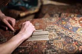 Person restoring a rug knot by knot
